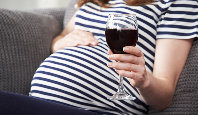 Close Up Of Pregnant Woman Drinking Red Wine